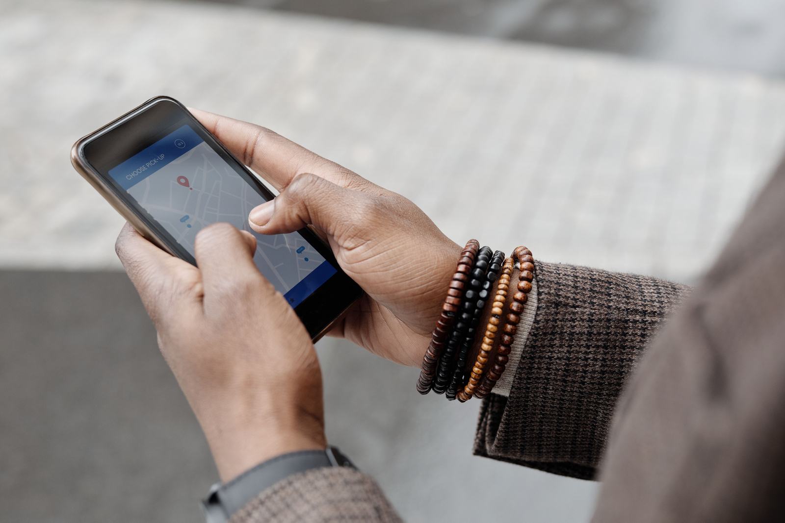 A hand checking a map app with location pins on a smartphone, standing in for the Apple Maps place card most local businesses have never claimed.