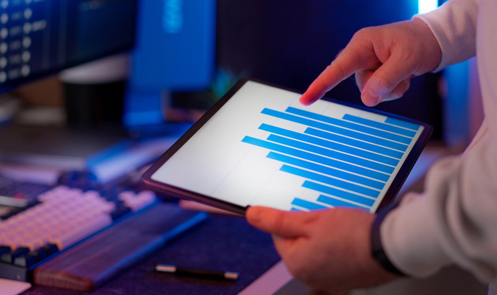 A person reviewing ad spend and lead data on a tablet, standing in for a contractor checking what a rising cost per lead is doing to a job's margin.