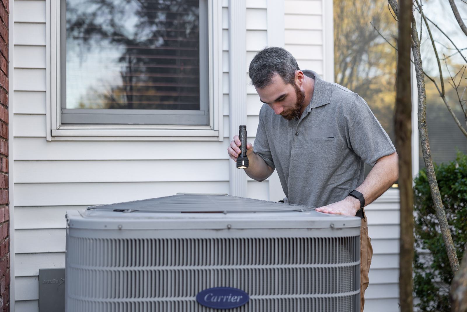A technician finishing a job at a real house, standing in for the moment a genuine blog topic idea actually shows up, not a stock list of generic headlines.
