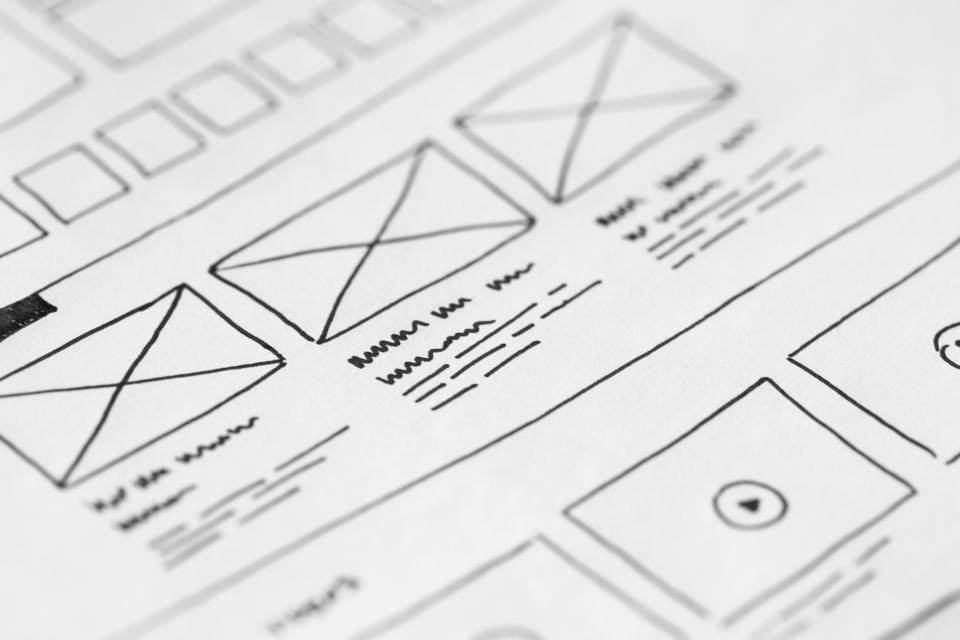 A hand-drawn wireframe sketch on paper, standing in for planning a page's layout around a booking call before any visual design starts.