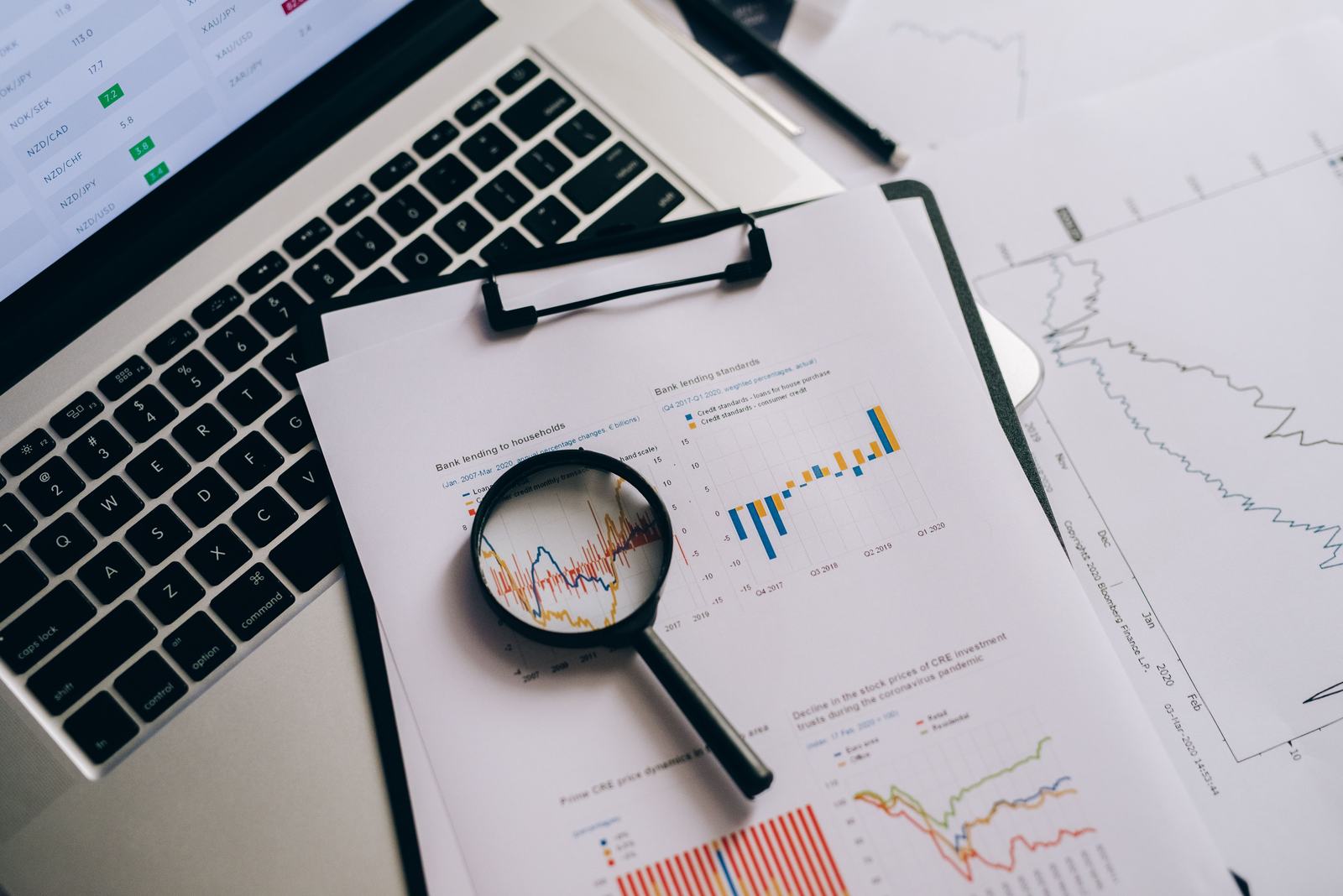 A magnifying glass held over real charts and data, standing in for the scrutiny a genuine case study needs to survive.