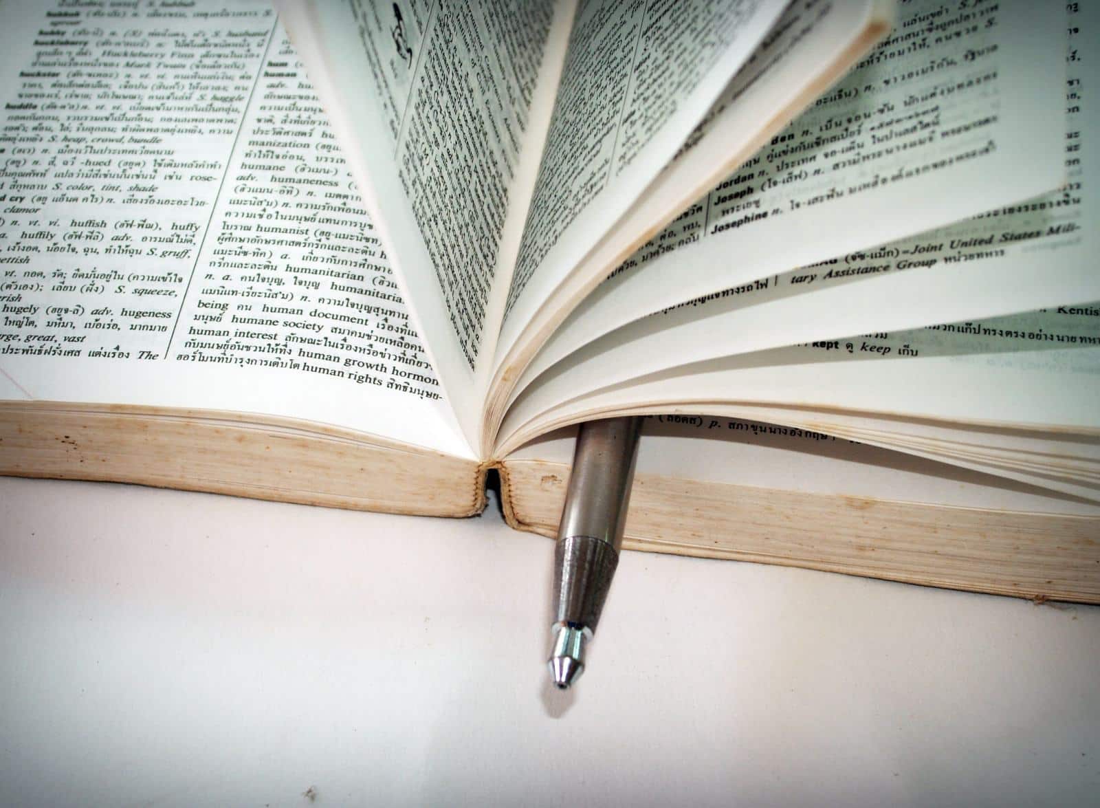 An open reference book with a pen marking the page, standing in for Google's own published AI search rulebook.