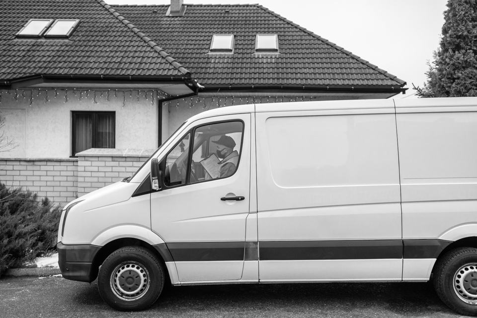 A white work van parked outside a house, standing in for a service business that has no storefront
