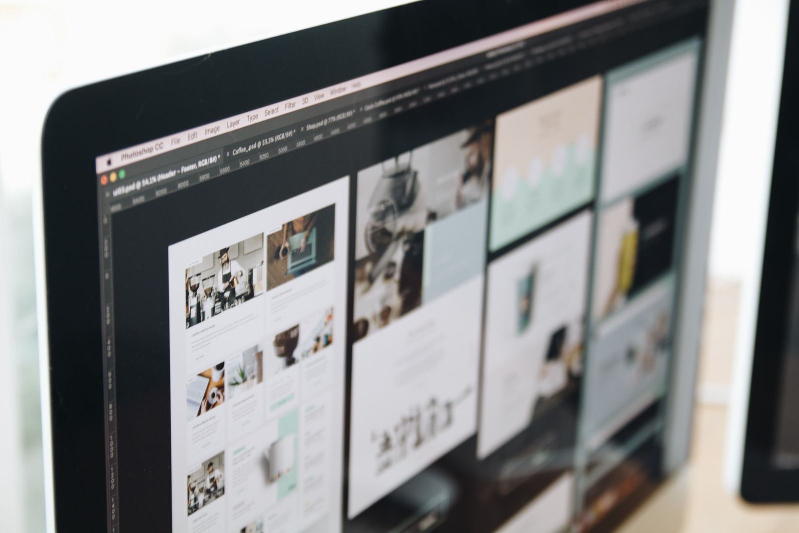 A close-up of website page mockups open on a design screen, standing in for the build-stage decisions that quietly decide whether Google can read the finished site.